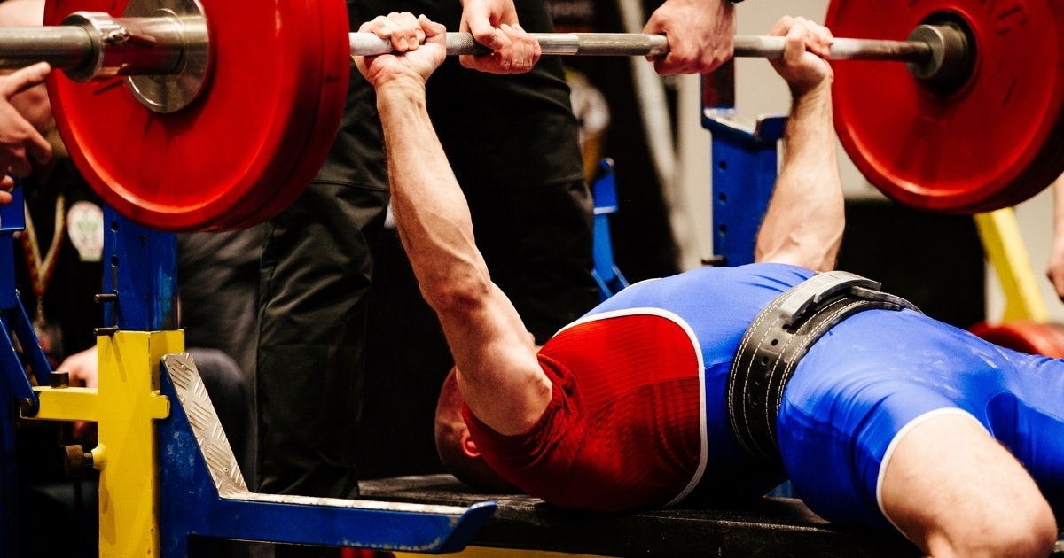 A man performs a bench press