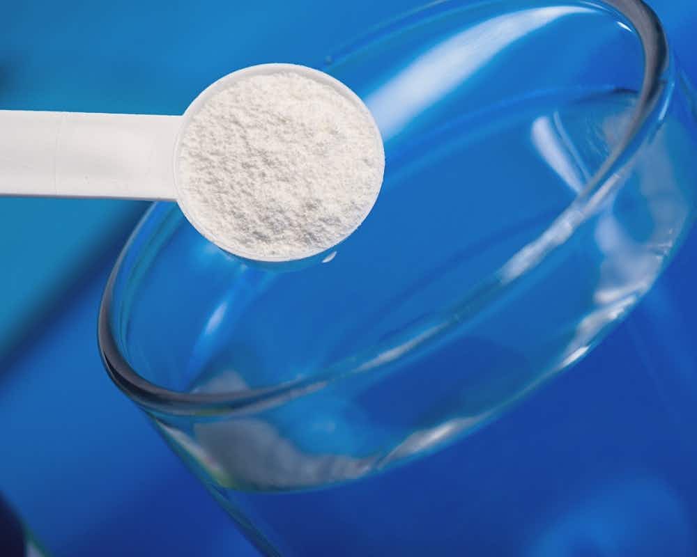 Scoop of IN-Perium with a cup of water
