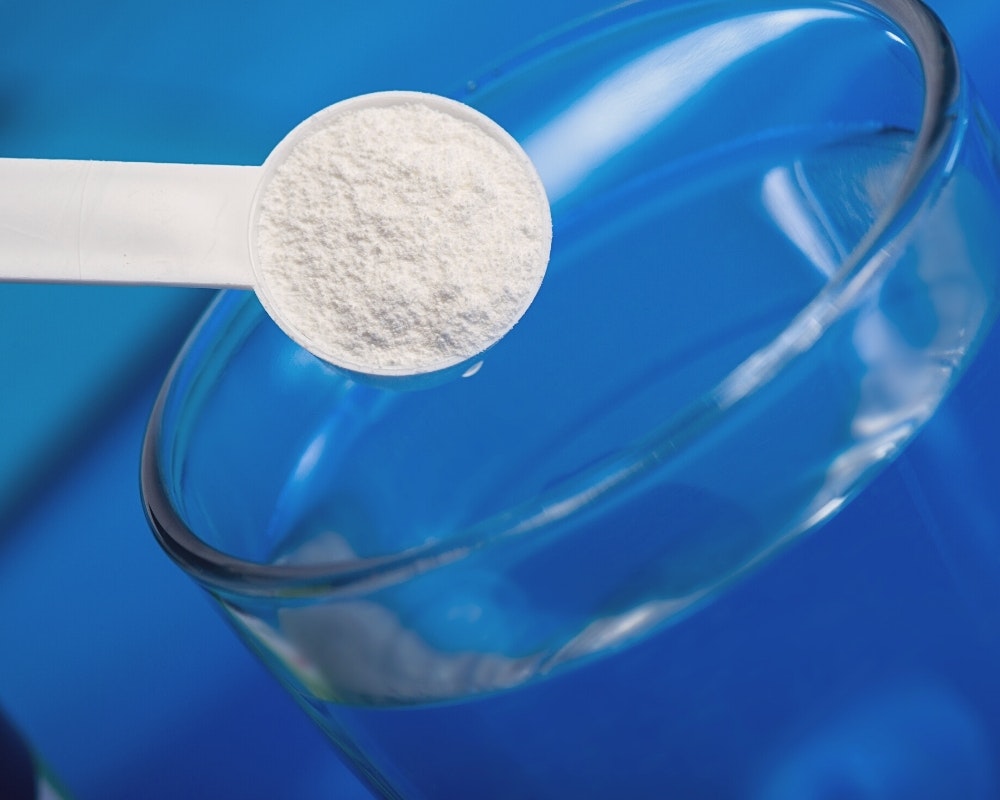 Scoop of IN-Perium with a cup of water