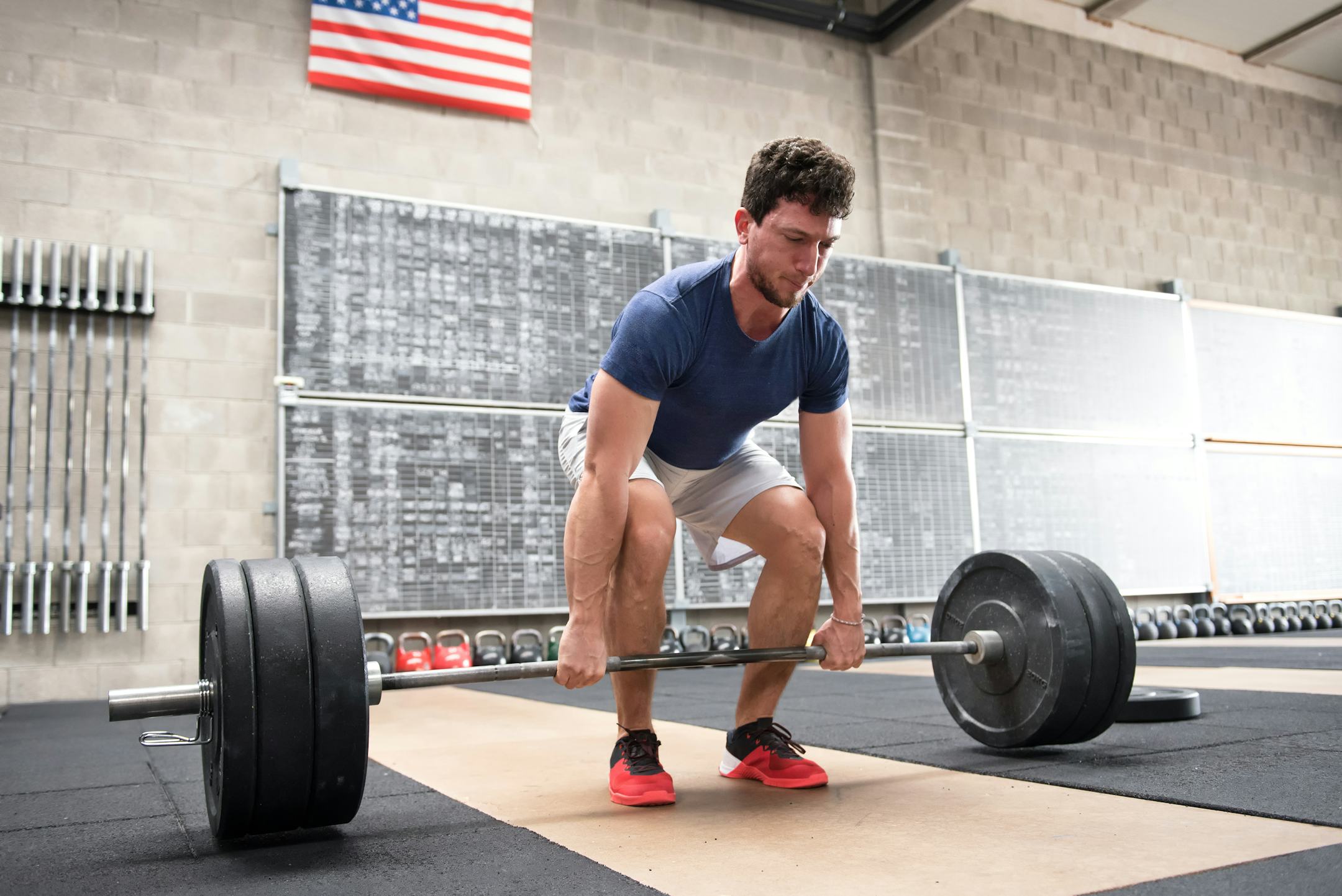 A man performs a deadlift with a barbell