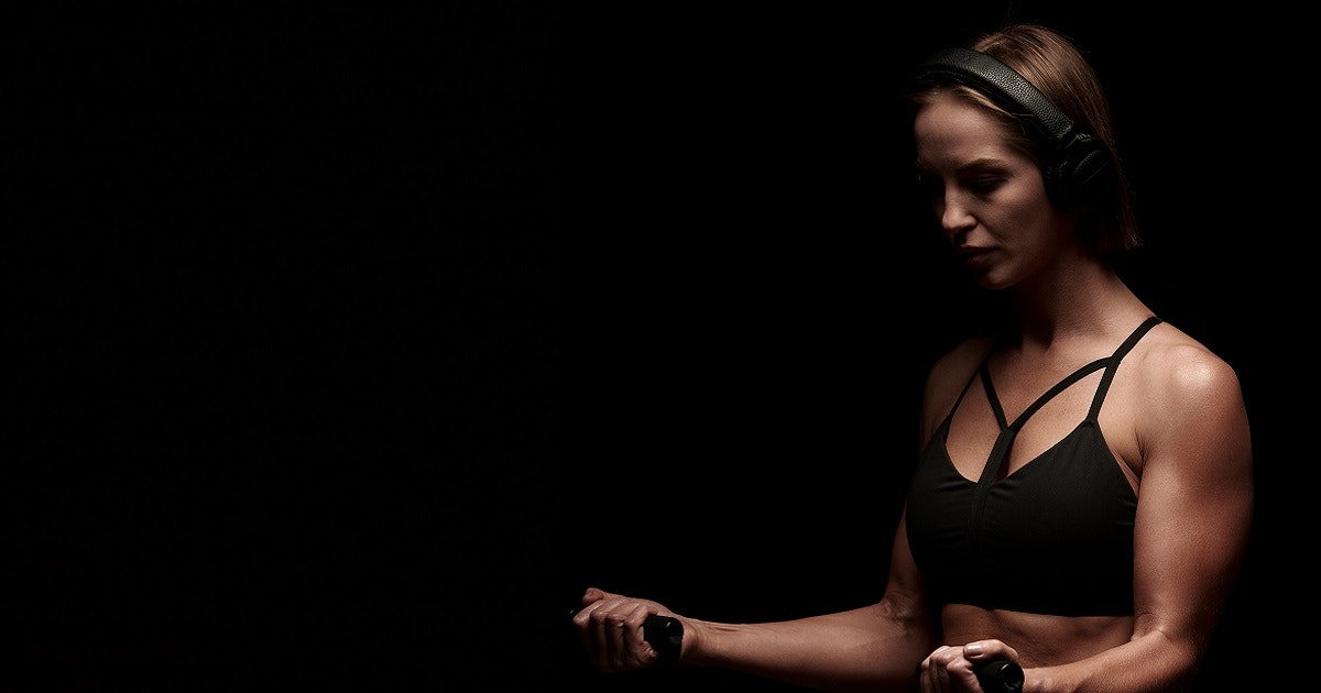Young woman training with resistance bands
