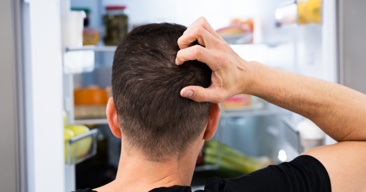 Hungry man looking at a fridge