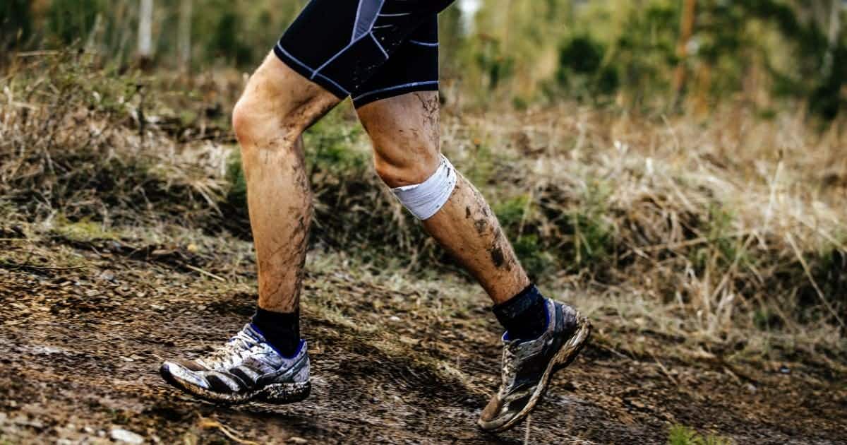 Man running with injured knee