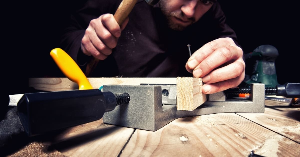 Man building a DIY X3 bar