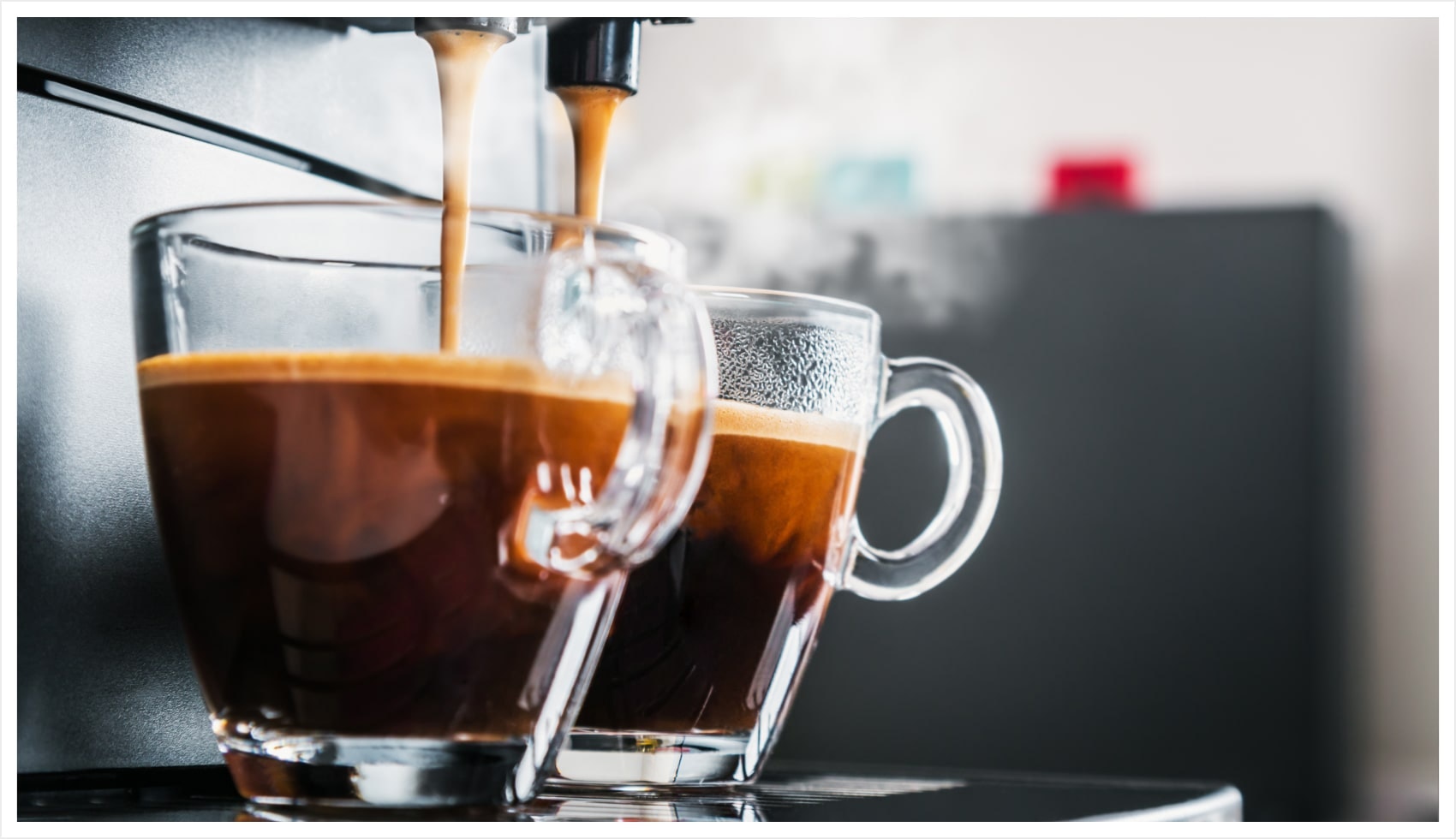 Espresso cups being filled by an espresso machine