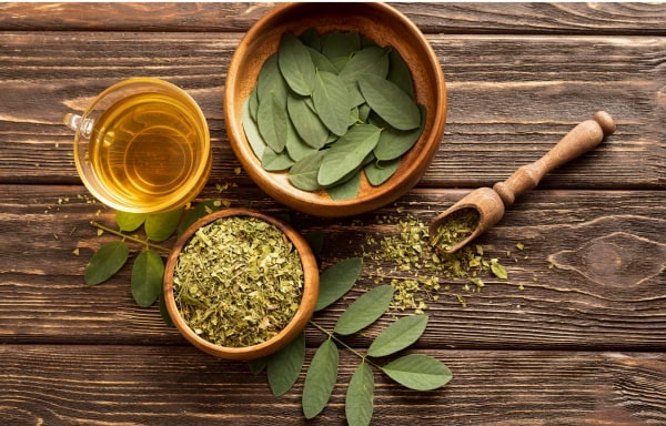 Tea leaves in cups on a wooden table