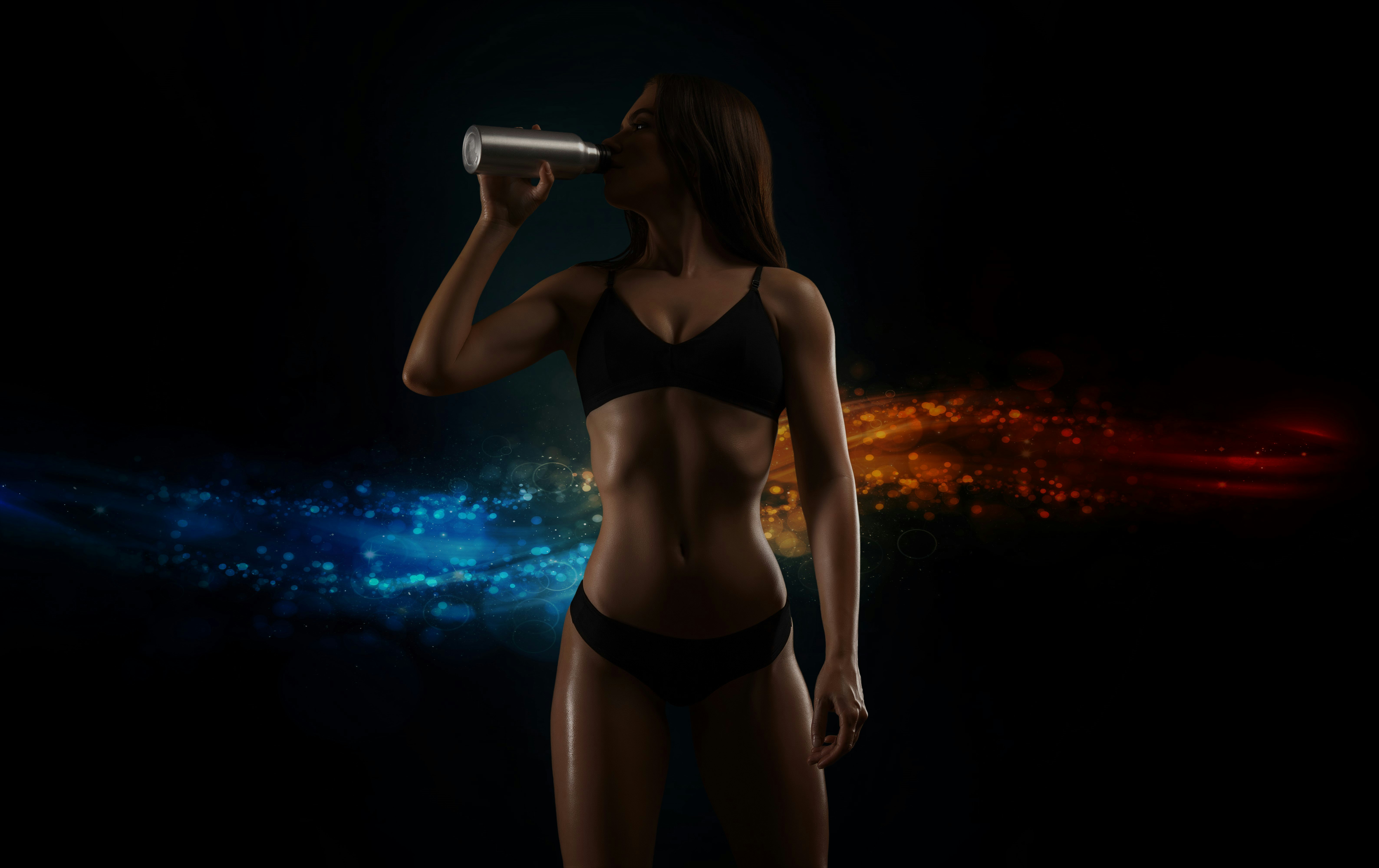 A woman is drinking a protein shake