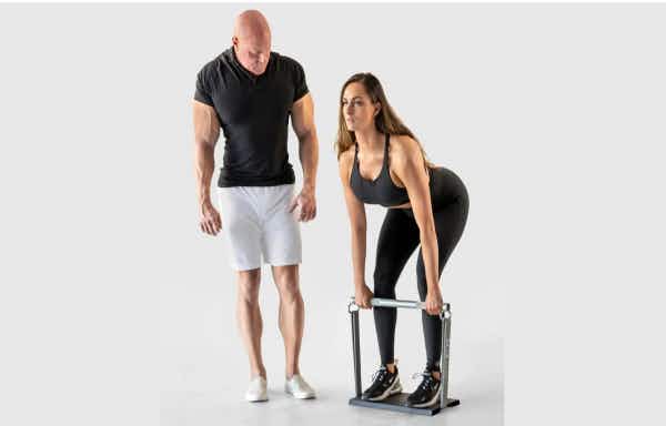 Dr. Jaquish with woman doing deadlifts with X3 and ground plate