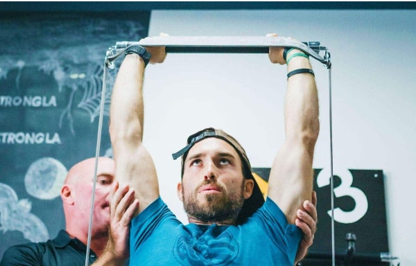 Man doing shoulder press with X3