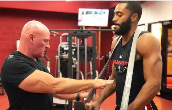 Dr. Jaquish helping athlete with X3 Bar