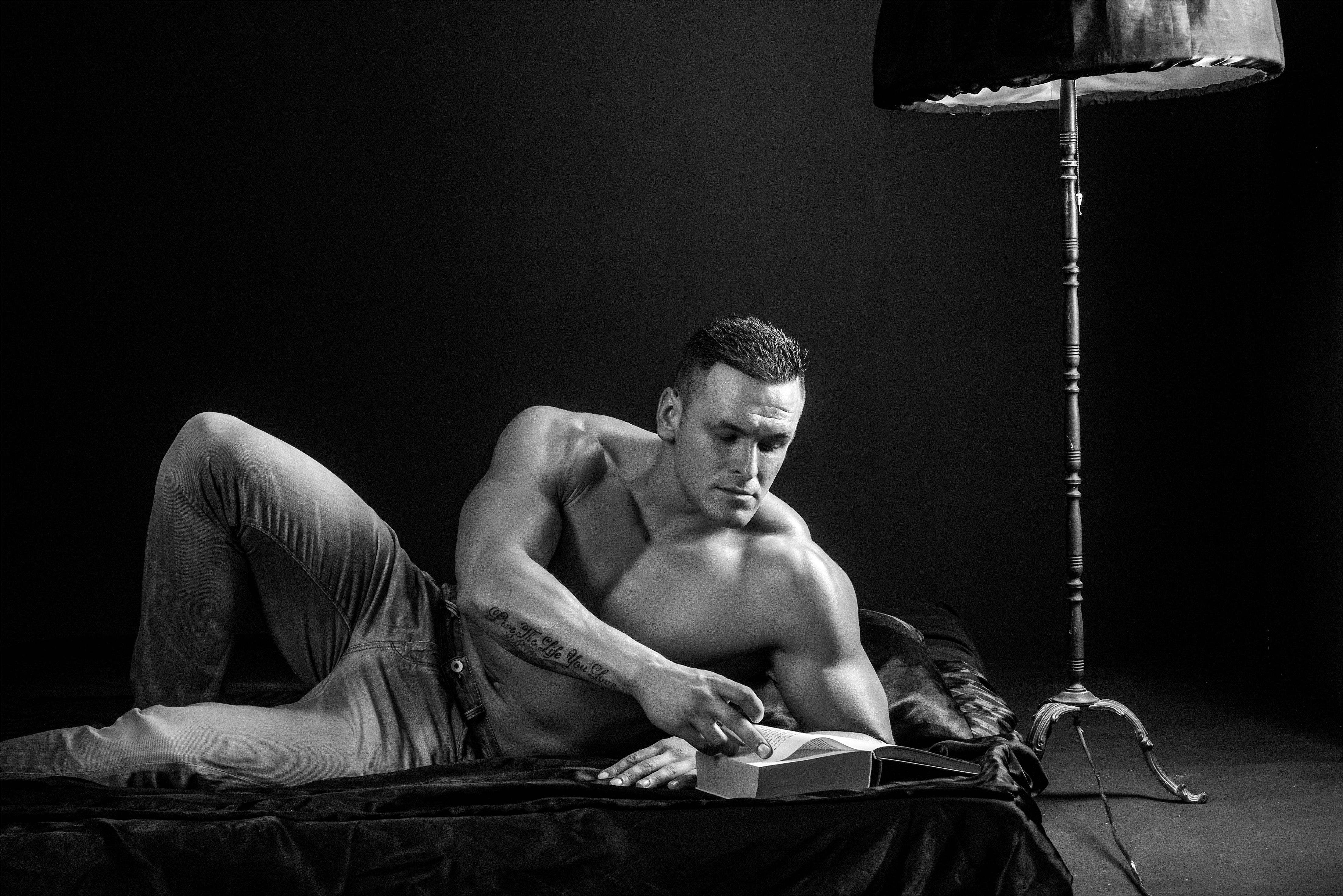 Strong guy reading weight lifting book