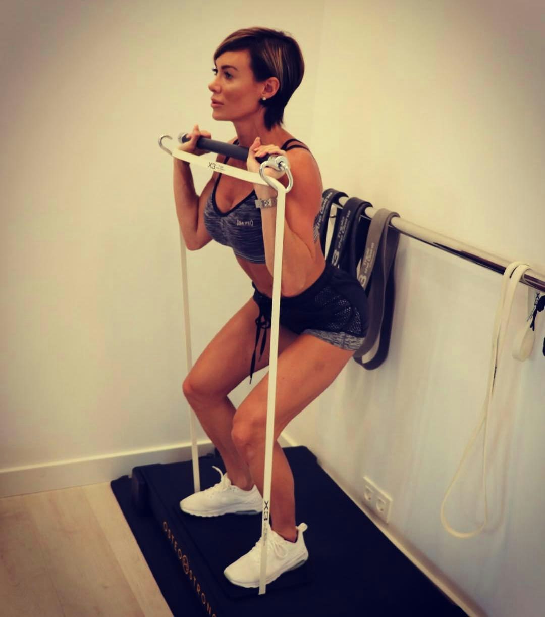 Woman using X3 with VibePlate