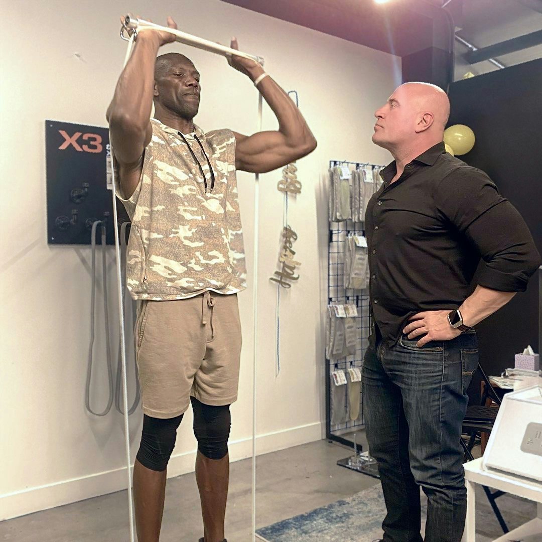 Dr. Jaquish coaching NFL Hall of Famer Terrell Owens on variable resistance training with X3