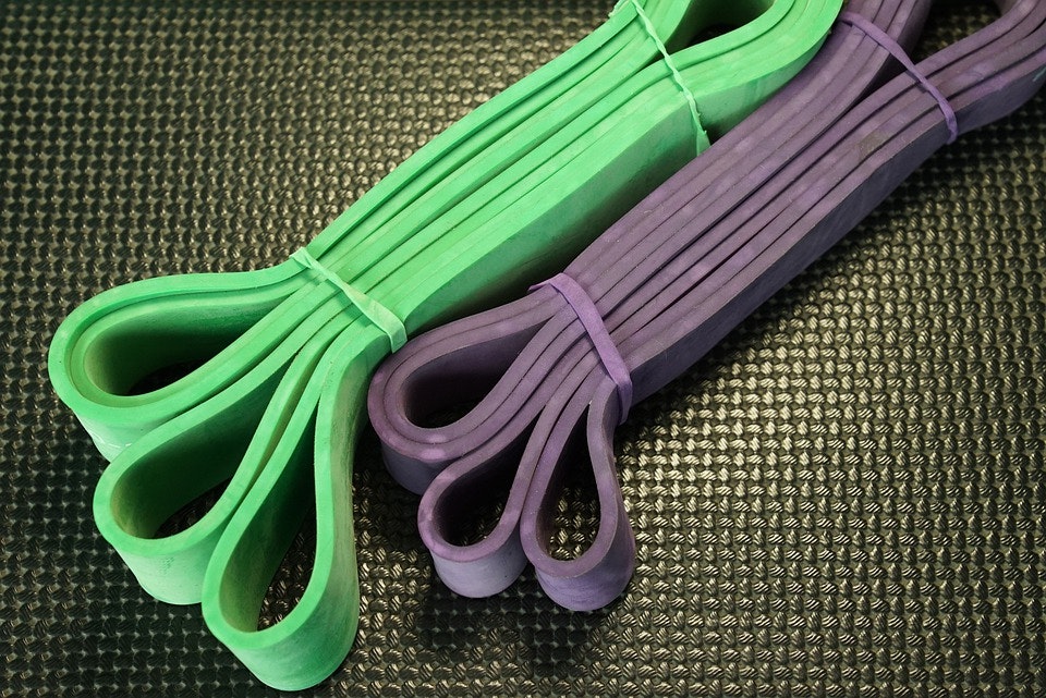 A green and a purple resistance band bound up